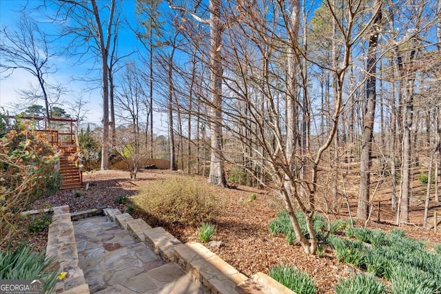 view of yard with stairway and a wooden deck