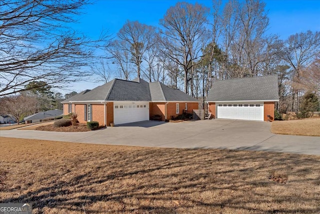 view of front of house with a garage, brick siding, and a front lawn