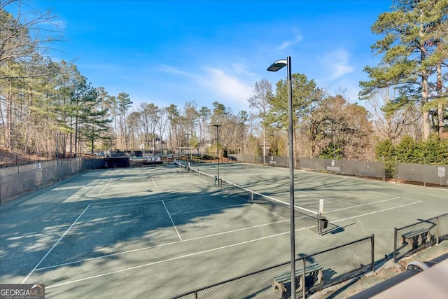 view of sport court featuring fence