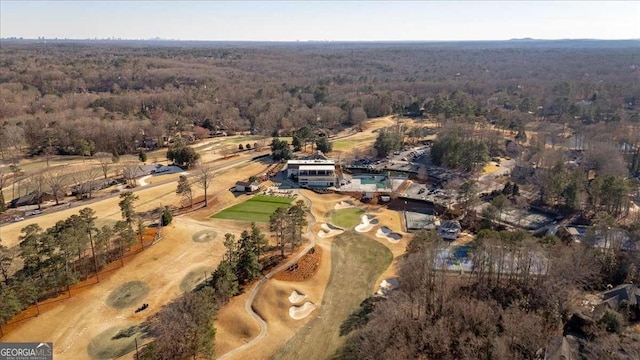 bird's eye view with a wooded view