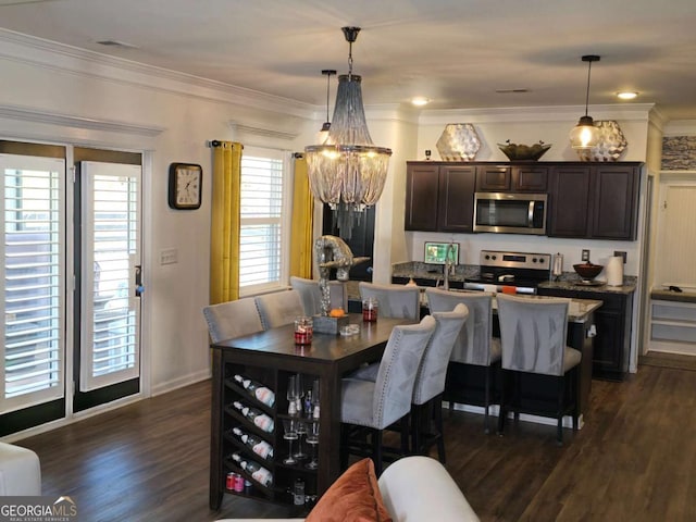 dining room with baseboards, a chandelier, dark wood finished floors, and crown molding