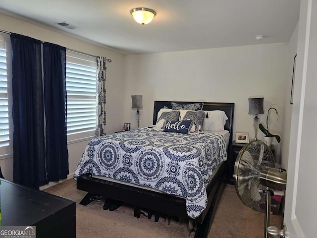 bedroom featuring carpet floors and visible vents