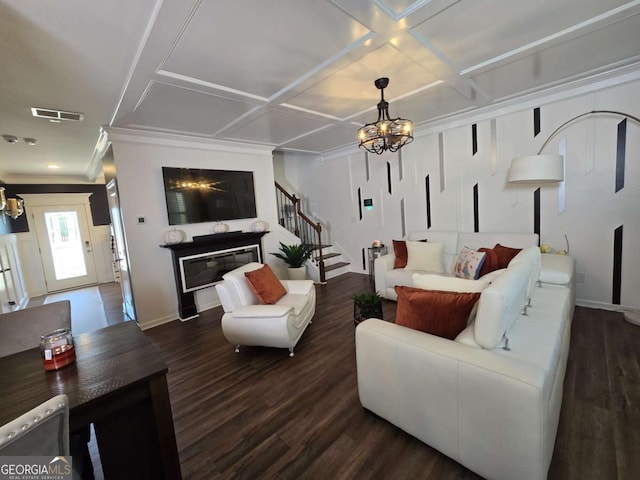 dining area with dark wood-type flooring, an inviting chandelier, visible vents, and crown molding