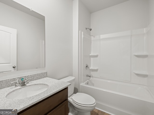 full bathroom with washtub / shower combination, vanity, and toilet