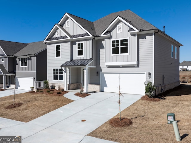 view of front facade featuring a standing seam roof, roof with shingles, board and batten siding, and a garage