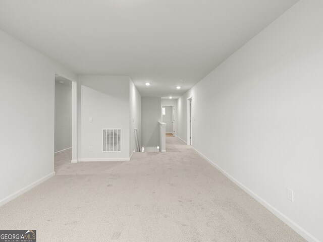 unfurnished room with light carpet, baseboards, visible vents, and recessed lighting