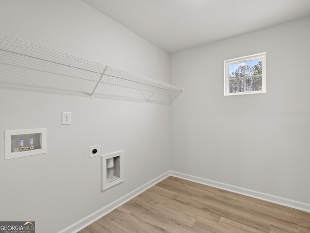 washroom featuring hookup for a washing machine, laundry area, baseboards, light wood-style floors, and electric dryer hookup