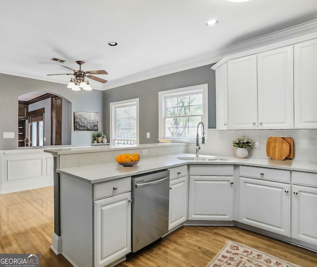 484 Martin St SE, Atlanta, GA 30312 - kitchen featuring dishwasher, ornamental molding, a peninsula, arched walkways, and a sink