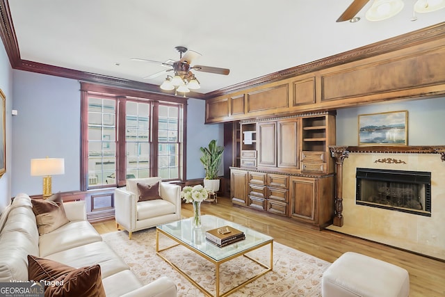 484 Martin St SE, Atlanta, GA 30312 - living room with a fireplace with flush hearth, light wood-type flooring, crown molding, and ceiling fan