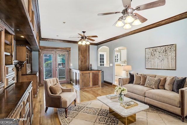 484 Martin St SE, Atlanta, GA 30312 - living room with ornamental molding, a ceiling fan, arched walkways, and light wood-type flooring