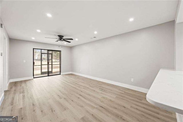 interior space with light wood-type flooring, baseboards, and recessed lighting