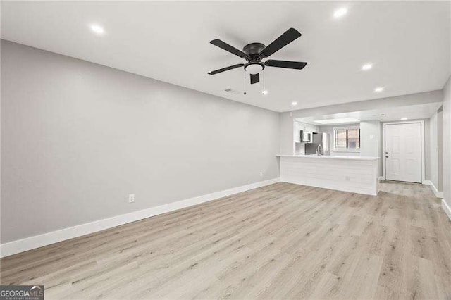 unfurnished living room with baseboards, ceiling fan, recessed lighting, and light wood-style floors