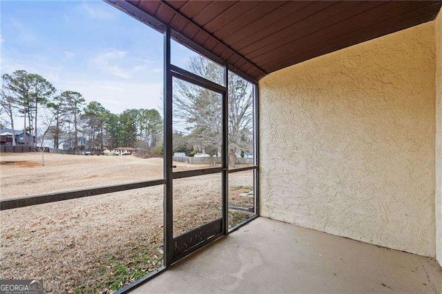 unfurnished sunroom featuring wooden ceiling