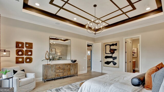 bedroom featuring light wood-style floors, coffered ceiling, a raised ceiling, and crown molding