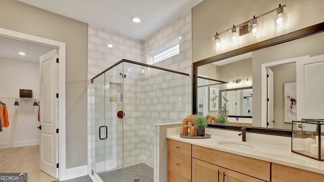 full bath featuring a stall shower and vanity