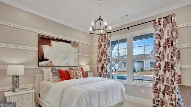 bedroom with baseboards, visible vents, a notable chandelier, and ornamental molding