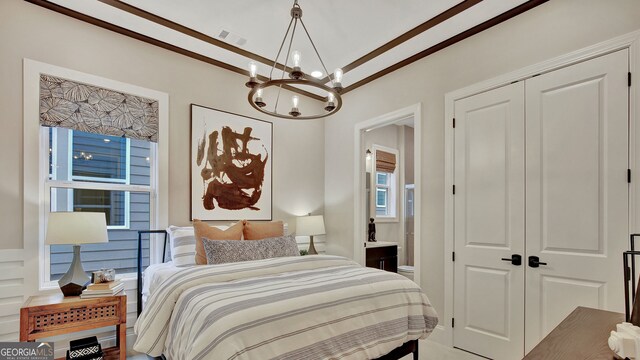 bedroom with a notable chandelier, visible vents, a closet, and ensuite bathroom