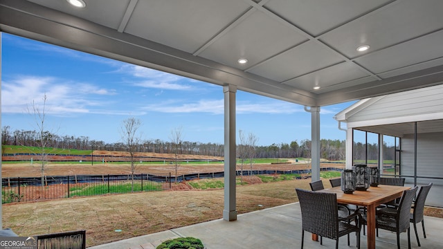 view of patio with outdoor dining space and fence