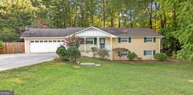 ranch-style house featuring a porch, fence, concrete driveway, a front yard, and an attached garage