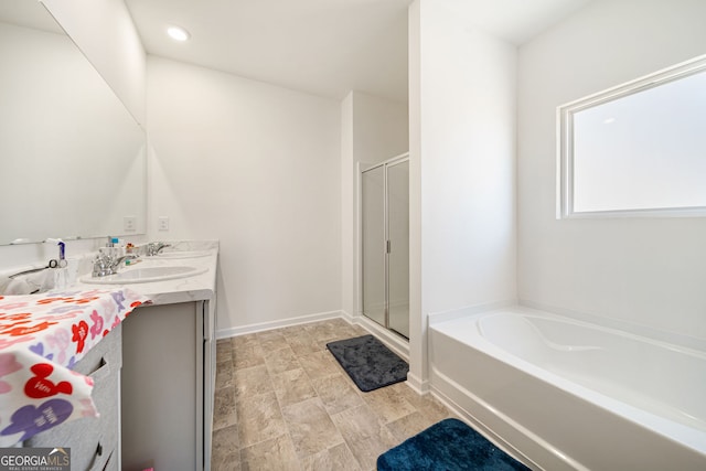 2030 Vidalia Ct, Dacula, GA 30019 - full bath featuring double vanity, a bath, a shower stall, and baseboards