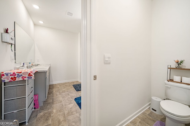 2030 Vidalia Ct, Dacula, GA 30019 - bathroom featuring vanity, toilet, recessed lighting, baseboards, and stone finish floors