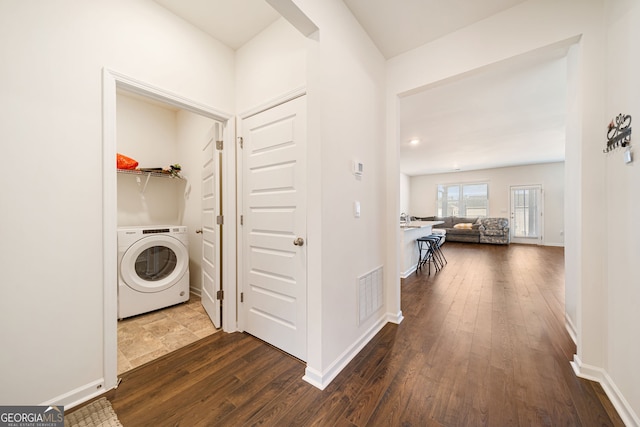 laundry room featuring washer / dryer, laundry area, visible vents, baseboards, and dark wood-style flooring