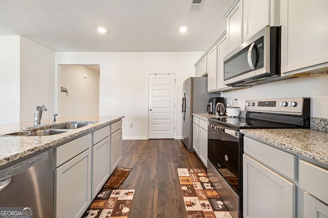 2030 Vidalia Ct, Dacula, GA 30019 - kitchen with appliances with stainless steel finishes, a sink, dark wood-style floors, light stone counters, and recessed lighting