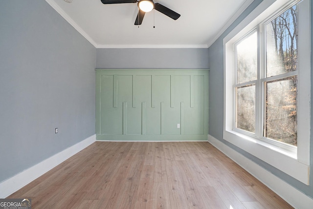 unfurnished bedroom with baseboards, ceiling fan, crown molding, and light wood finished floors