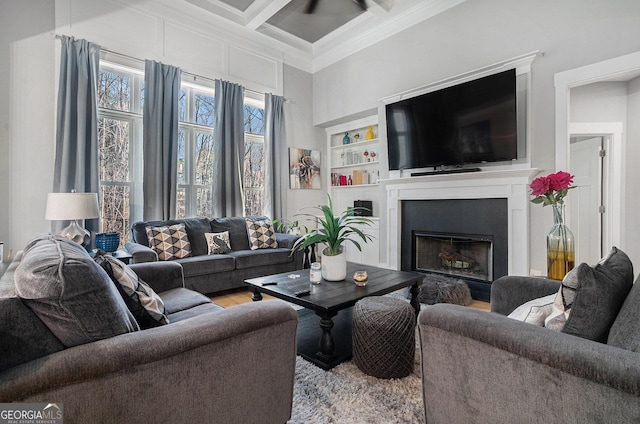 living room with beamed ceiling, coffered ceiling, wood finished floors, a fireplace, and crown molding