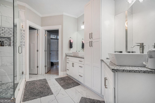 bathroom with vanity, baseboards, a shower stall, crown molding, and marble finish floor