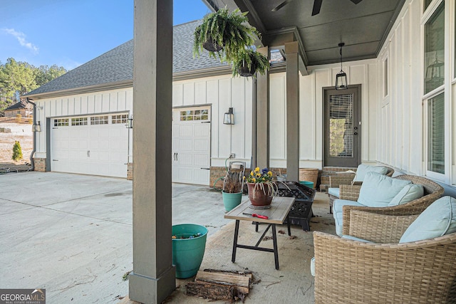 view of patio with concrete driveway, outdoor lounge area, and a garage