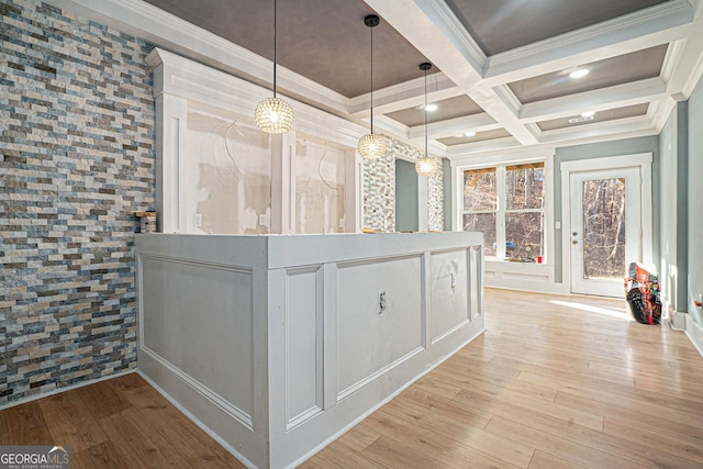 hallway with coffered ceiling, light wood-type flooring, and ornamental molding