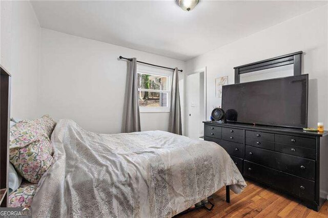 bedroom featuring wood finished floors