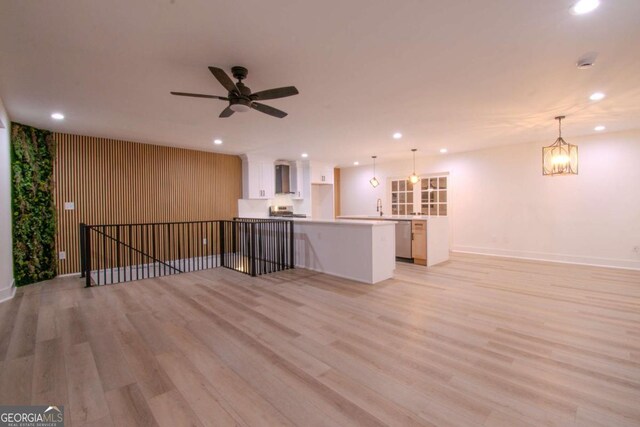 unfurnished living room featuring a sink, light wood-style flooring, and recessed lighting