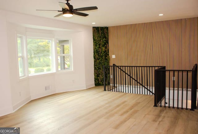 spare room featuring a ceiling fan, recessed lighting, baseboards, and wood finished floors