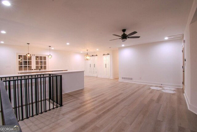 unfurnished room with recessed lighting, visible vents, light wood-style flooring, ceiling fan, and baseboards