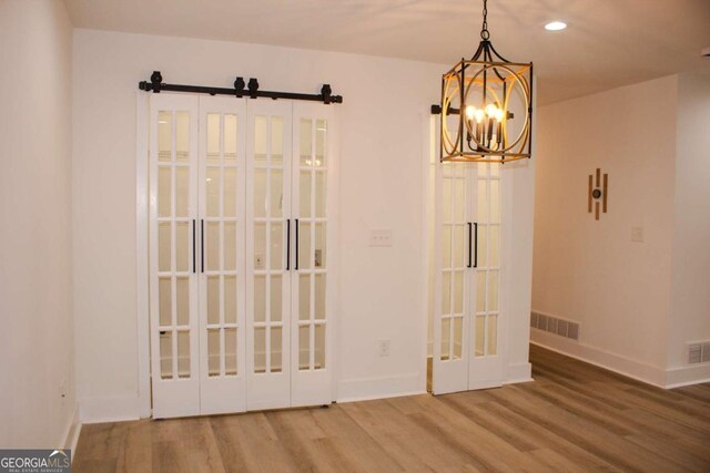 interior space with recessed lighting, visible vents, wood finished floors, a chandelier, and baseboards