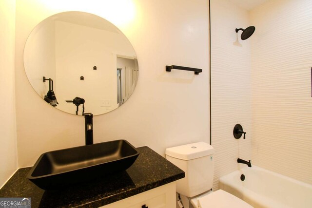 bathroom with toilet, shower / tub combination, and vanity