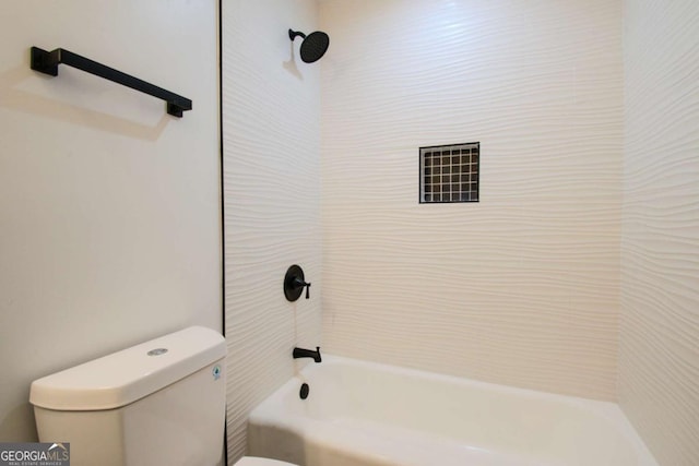 bathroom with washtub / shower combination and toilet