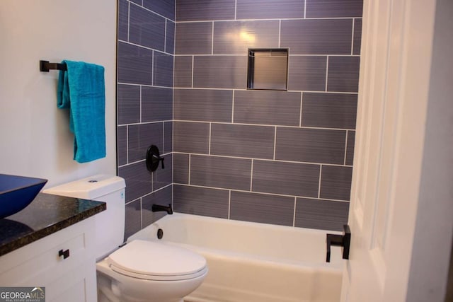 bathroom featuring toilet, shower / washtub combination, and vanity