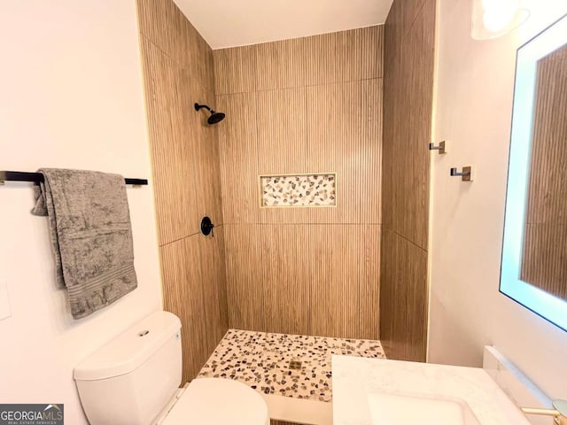 bathroom with tiled shower and toilet