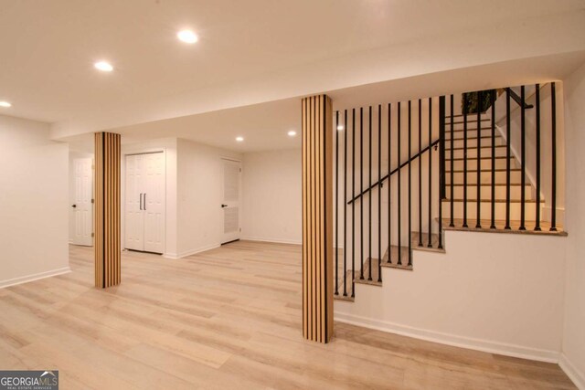 finished basement featuring baseboards, wood finished floors, and recessed lighting