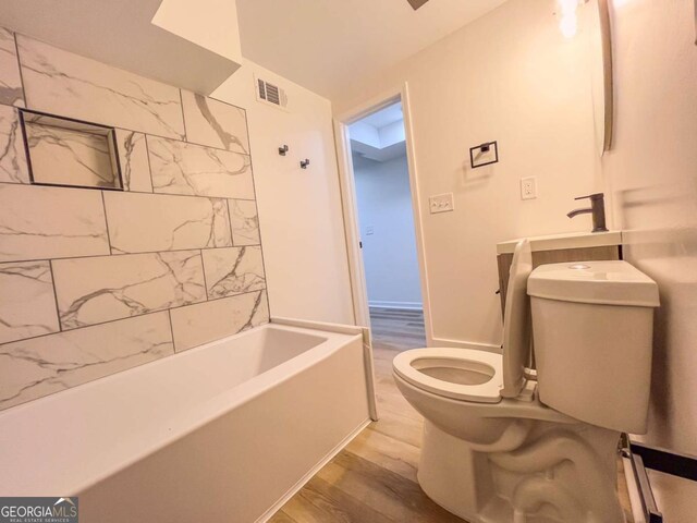 full bathroom with toilet, wood finished floors, and visible vents