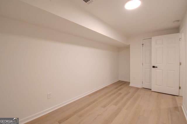 unfurnished bedroom featuring light wood-type flooring and baseboards