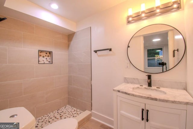 bathroom with toilet, recessed lighting, vanity, baseboards, and tiled shower