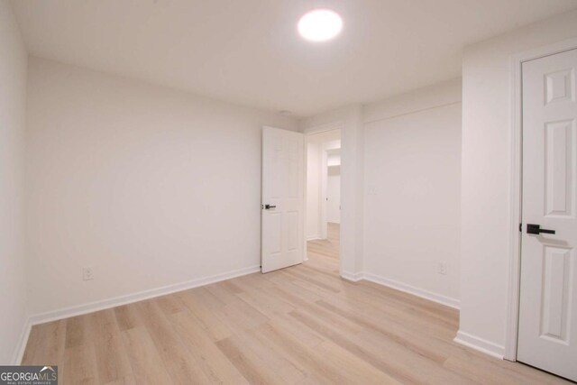 unfurnished bedroom with light wood-style floors and baseboards