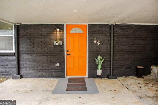 entrance to property with brick siding