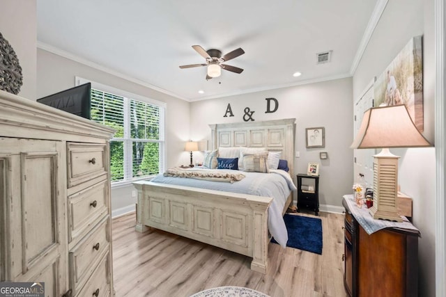 bedroom with light wood-style flooring, visible vents, and ornamental molding