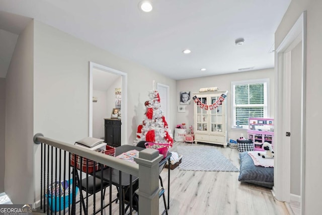 game room with recessed lighting and wood finished floors