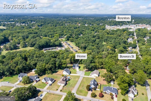 birds eye view of property featuring a forest view